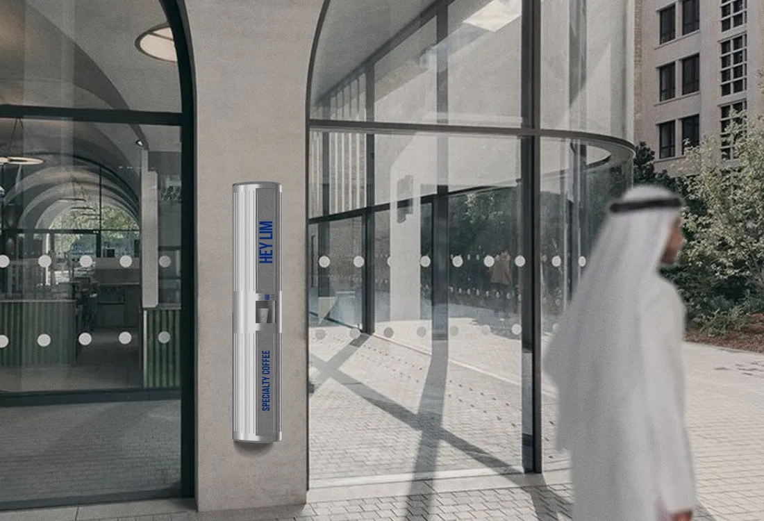 HEYLIM autonomous coffee kiosk in an outdoor plaza with contemporary architecture in the UAE